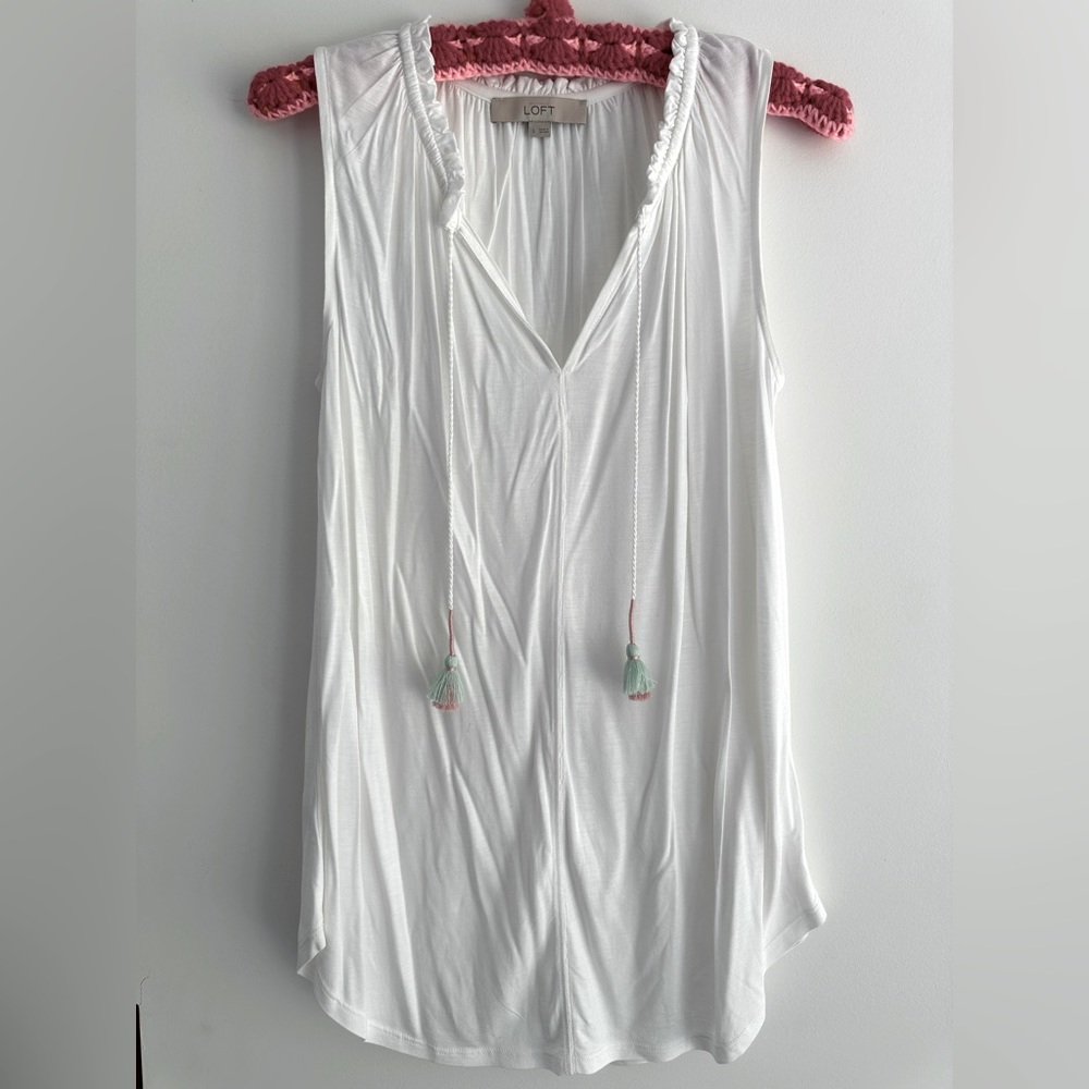 Sleeveless white top with tassels